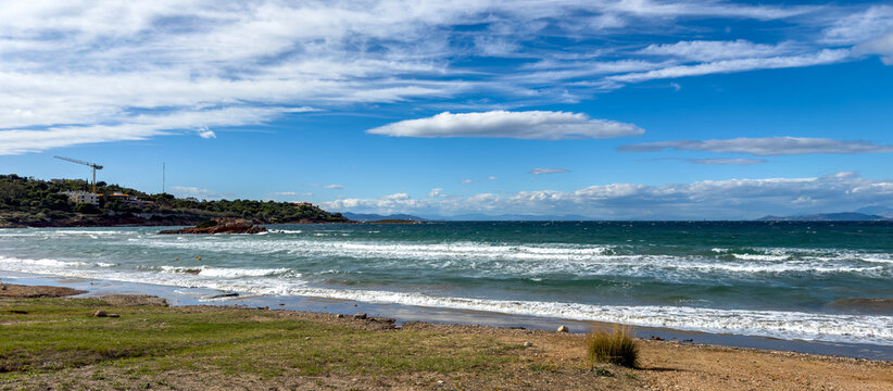 Waves Breaking on Kavouri Beach Shore under Bright Blue Sky in Vouliagmeni Attica Greece