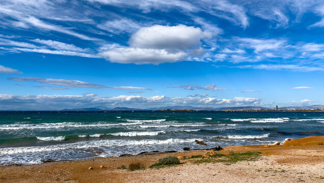 Sunny coastal view from Kavouri Beach toward the distant Ellinikon project in Attica Greece