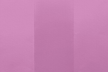 Fototapeta premium A textured pink paper background with three vertical sections.