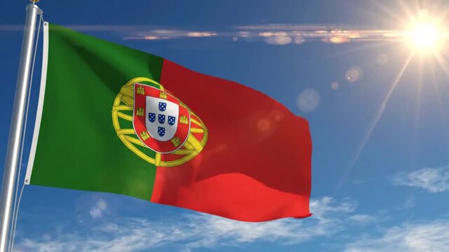 National flag of portugal waving against a bright blue sky with sun flare