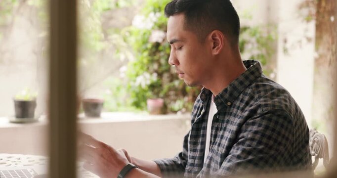 Man texting on smartphone, working alone and taking break at home. Digital tools, mobile connection and tech let people work online. Remote workers are distracted, lonely and isolated vs office staff