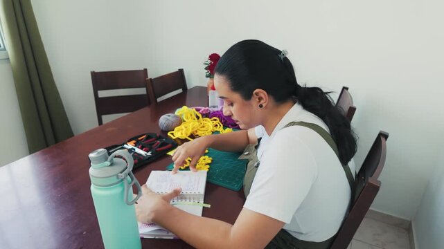 Woman working at home on her craft project