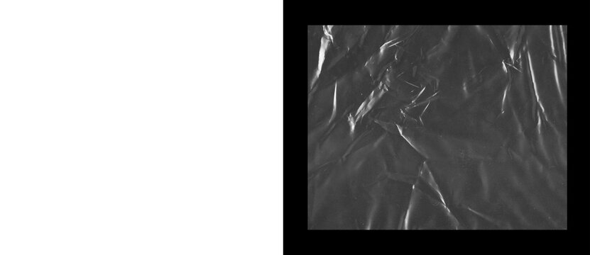 Crumpled black plastic texture background, wrinkled dark synthetic material with highlights, abstract creased polyethylene surface for industrial design