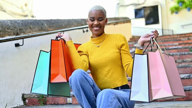 Happy afro latina woman laughing with shopping bags during luxury retail experience cheerful consumer lifestyle concept with modern fashion and positive urban energy