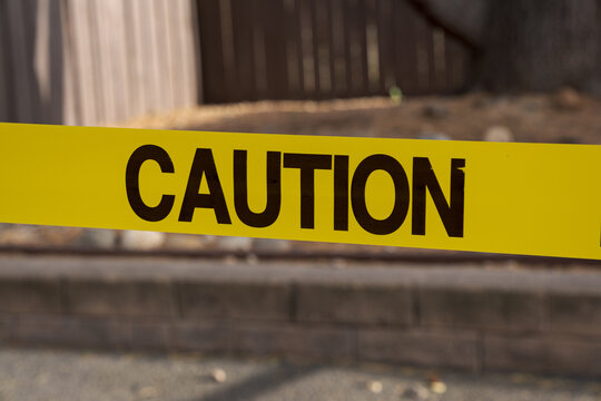 Close Up Caution Tape Marking Hazardous Restricted Area showing a restricted location and warning about potential hazards for visitors and pedestrians
