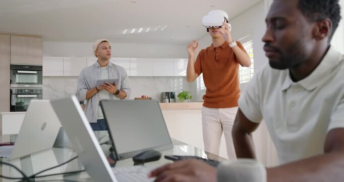 Diverse male team watching Asian man putting on white VR headset, showing menu and handing headset