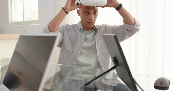 Man lifting white VR headset off glass desk home office, fitting over eyes exploring scene