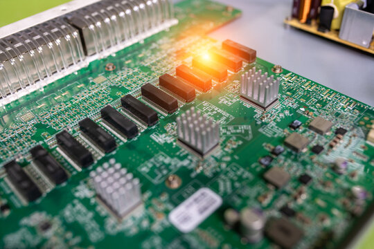 High-resolution close-up of a circuit board with colorful electronic components and glowing indicator lights