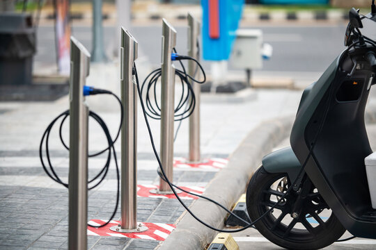 Electric scooter charging station in urban city with charging ports and infrastructure