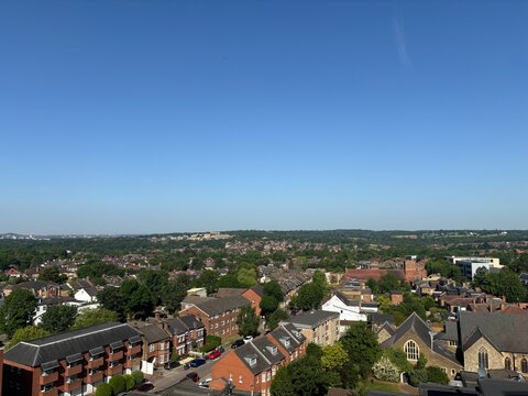 High Angle Drone Style View of North Finchley Looking West Towards Mill Hill and Dollis Valley London With Green Trees Blue Sky And Red Bricked Buildings 