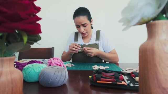 Artisan woman creating handmade macrame at home workshop