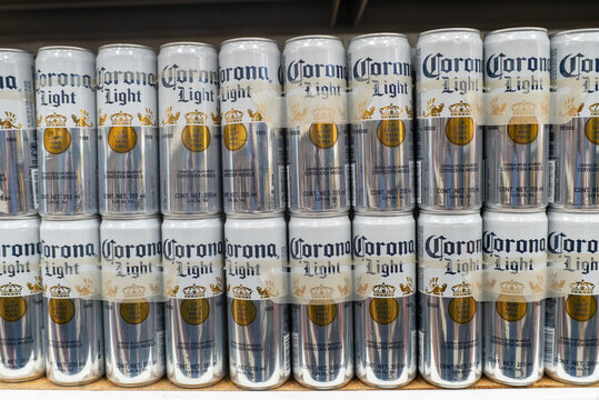 Villa de Alvarez, Colima. Mexico. May 15, 2026: Multiple stacks of Corona Light beer cans neatly arranged in a commercial setting