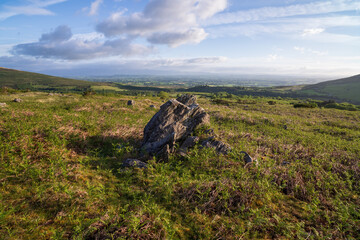 Large boulder on Irish moorland with panoramic valley and distant sea view © Viktor