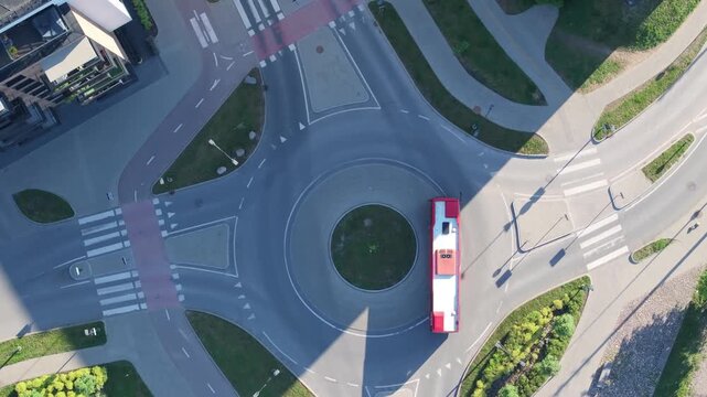 Bus riding through city, aerial top down view