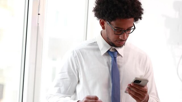 businessman with mobile phone and successful reaction