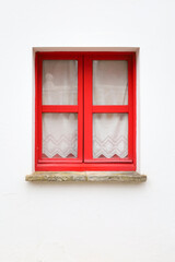 Obraz premium Red wooden window with curtain in Tazones town, Asturias