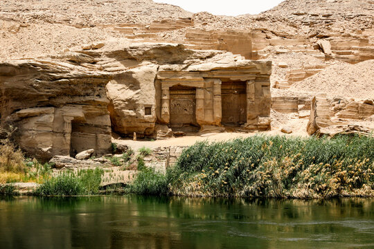 Ancient rock-cut ruins viewed from the Nile in Egypt