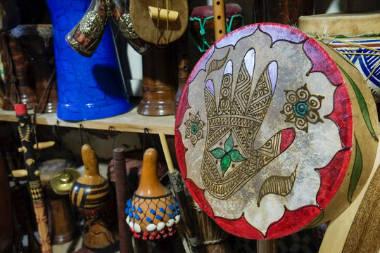 Decorative hand drum with metallic hamsa design