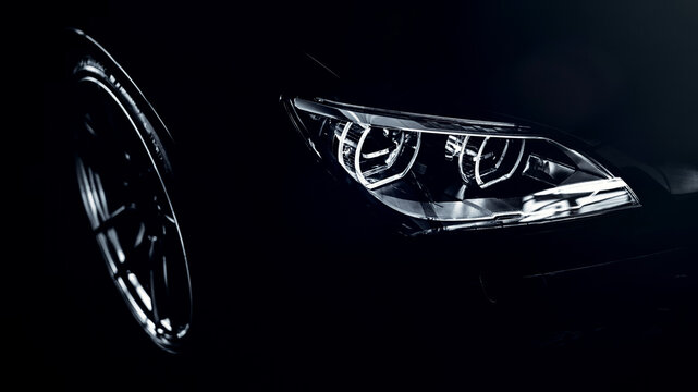 Modern sports car headlight detailing on dark background