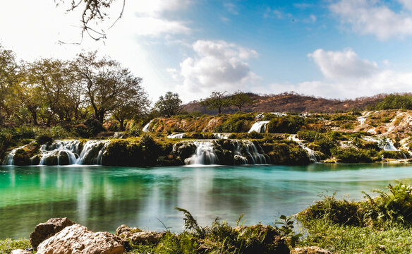 Long exposure of waterfalls and emerald pools at Wadi Darbat in Salalah, Oman
