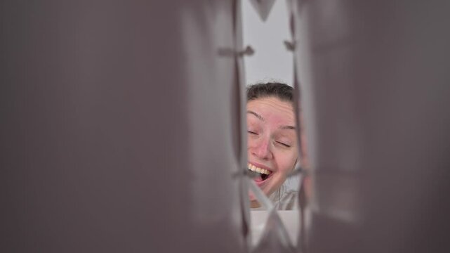 A Caucasian woman looks into a bag and is pleasantly surprised. Inside view.