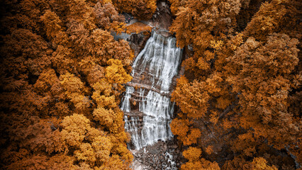 Adventurous traveler exploring the spectacular Cascades du Herisson in France © Christopher