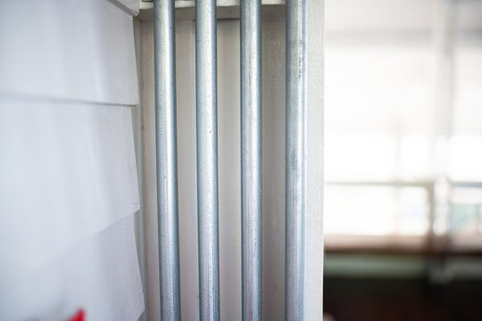 Modern Metal Poles Near Light-Reflected Windows