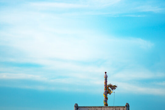 Unique decorative pole on rooftops against sky