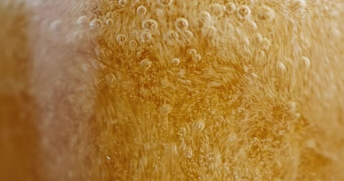 Extreme Macro of Effervescent Beer Bubbles and Golden Carbonation

