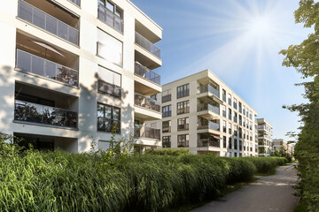 Obraz premium Cityscape of a residential area with modern apartment buildings, new sustainable development and green urban landscape in the city, concept for construction industry and real estate
