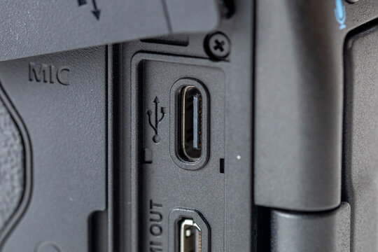 Close-up of a professional mirrorless camera side interface panel featuring USB TYPE-C and HDMI OUT ports, detailed view of connectivity sockets and protective rubber cover