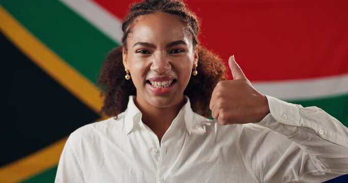 Girl, face and thumbs up with South Africa flag with smile, national pride and patriot by background. Woman, agreement and yes emoji in portrait with symbol, respect and sign for loyalty to country