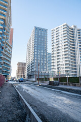 Obraz premium Urban street under construction with modern highrise buildings in daylight.