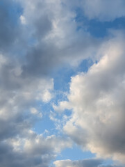 Obraz premium Towering White and Gray Clouds Framing a Bright Blue Sky in a Peaceful Open Atmosphere