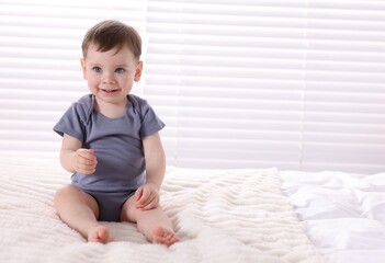 Fototapeta premium Cute little baby boy on bed at home. Space for text