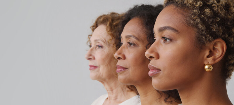 Three woman of different age and ethnicity standing in profile. Diversity and beauty of female generations. Concept of aging, equality, empowerment, and skincare skin positivity.