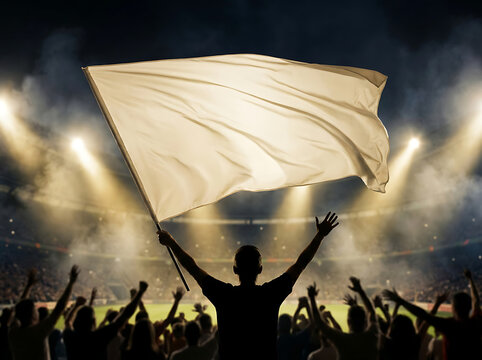 Silhouette of sports fan waving blank flag in stadium