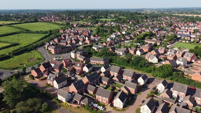 Aerial drone footage of Three Mile Cross in Berkshire, England, showcasing residential neighbourhoods, surrounding countryside, and suburban development