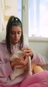 Closeup of teen repairing fabric with care and precision