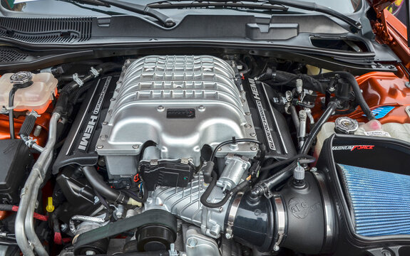 High performance supercharged HEMI V8 engine featuring upgraded intake system and meticulous mechanical detailing stands as centerpiece of modern American muscle engineering