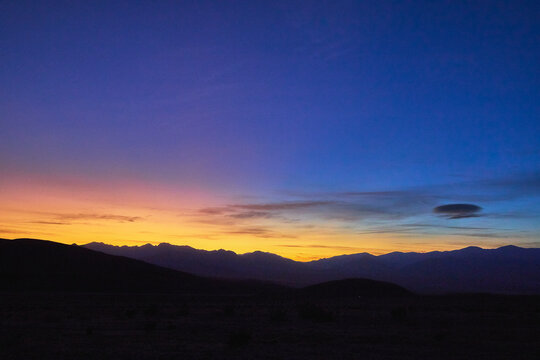 Sunset Sky Over Death Valley Desert Silhouette With Distant Mountains