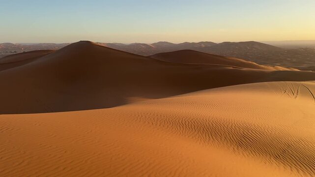 Golden sunrise over Sahara sand dunes near Merzouga, Morocco desert
