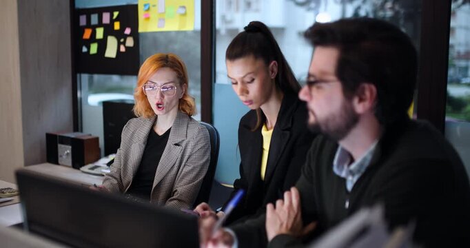 Meeting in an office with three people discussing ideas and taking notes in the afternoon at a workplace