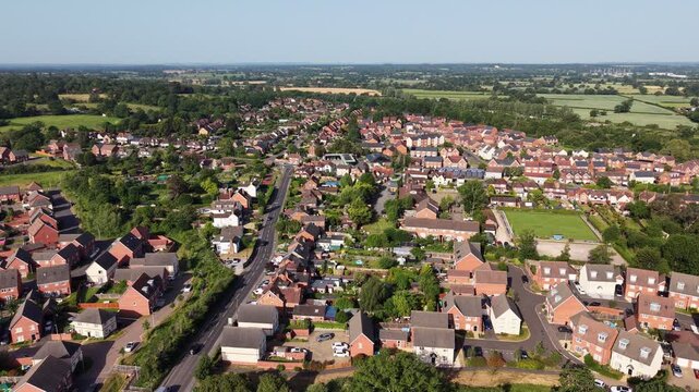 Aerial drone footage of Three Mile Cross in Berkshire, England, showcasing residential neighbourhoods, surrounding countryside, and suburban development