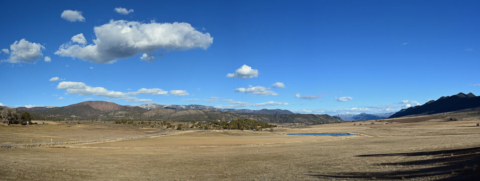 Panoramic view of agricultural fields of Grass Valley in Garfield County, Colorado on sunny winter morning.