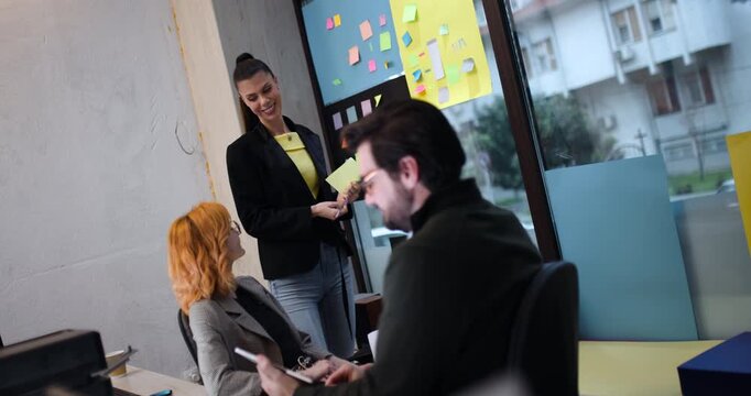 Team members discuss ideas and strategies during a brainstorming session in an office space located in the city on a weekday morning