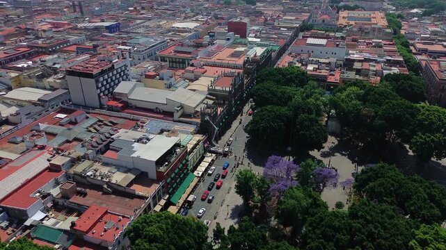 Puebla Zocalo Historic Plaza with Palacio Municipal Architecture and Central Fountain Surrounded by Green Trees Aerial Flying Drone POV Shot in Mexico