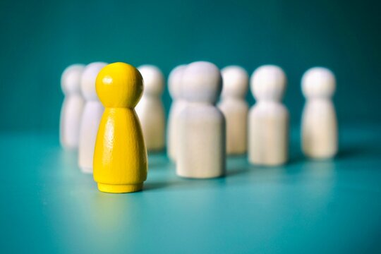 Close Up Profile of Yellow Figure Leading White Team