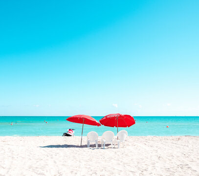 red beach umbrella with chairs miami florida