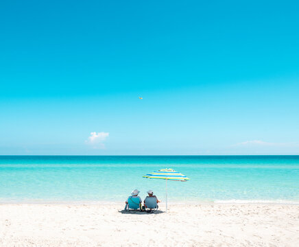 couple beach chairs umbrella miami florida